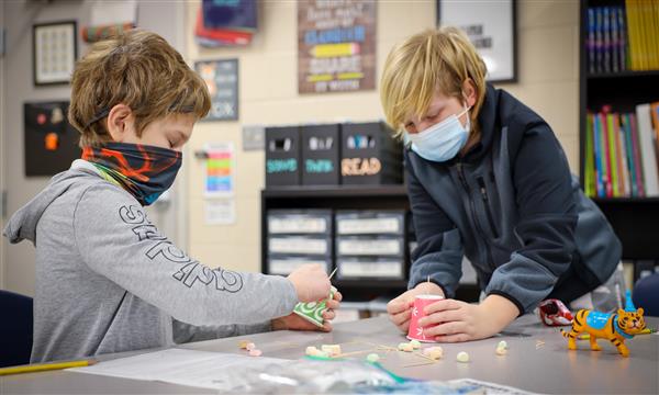 students work to build a bridge